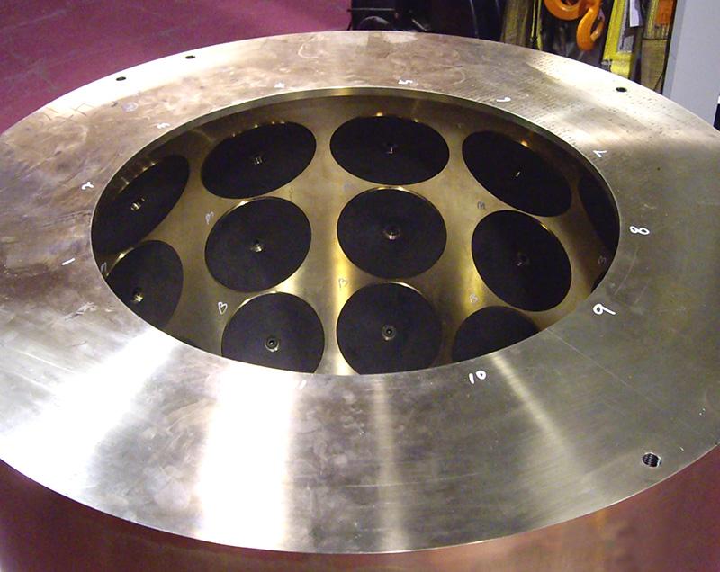 A pintle housing (two halves assembled), fully machined with graphite lubrication disc inserts, for a very large bridge. The pintle housing holds a pintle ball, providing motion buffering that allows large bridges to safely sway and flex.